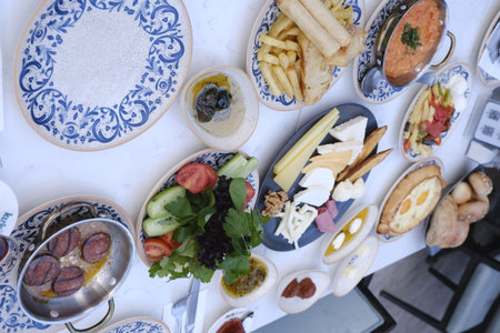 Traditional Turkish and Greek dinner appetizer table with meat, vegetables and cheeseの写真素材