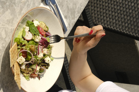 Healthy salad in the hands of a woman. Selective focus.の写真素材