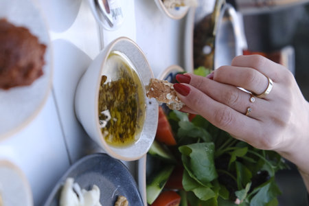 Female hands holding a cup of cappuccino, close upの写真素材