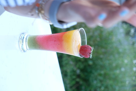 Strawberry smoothie in a glass on the white table.の写真素材
