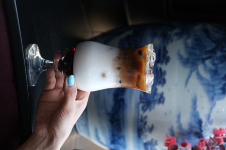 Woman's hand holding a glassの写真素材