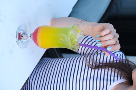 Young woman drinking cocktail in cafe, closeup. Summer vacation conceptの写真素材