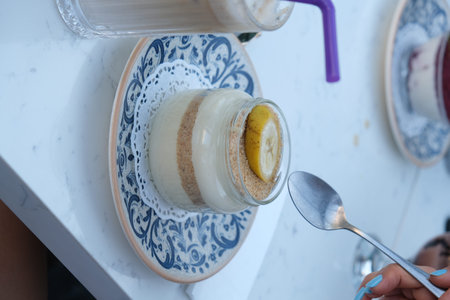 Close up of a glass of yogurt on the table.