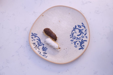 Dessert in a ceramic plate on a white marble table. top view
