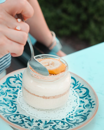 Vanilla mousse in a glass jar on the tableの写真素材