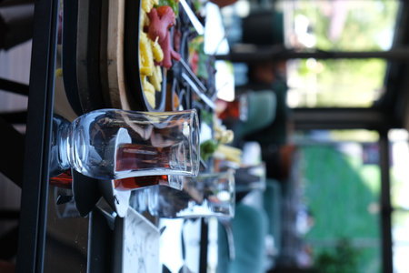 Close up of a bar counter with a glass of wine and snacksの写真素材