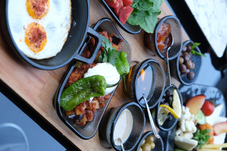 Breakfast set with fried eggs, vegetables and fruits on wooden tableの写真素材