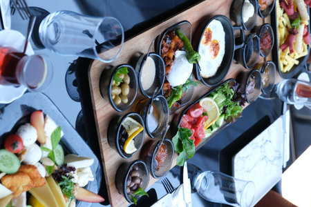 Tray with different appetizers on table in restaurant, top viewの写真素材
