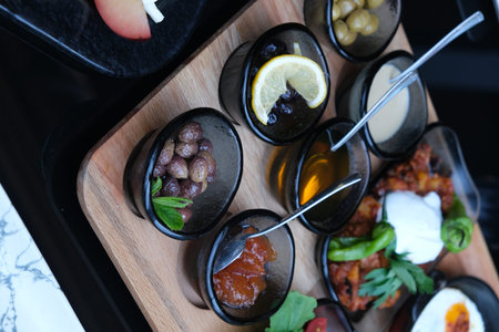 Closeup of assorted appetizers served on a wooden board in a restaurant