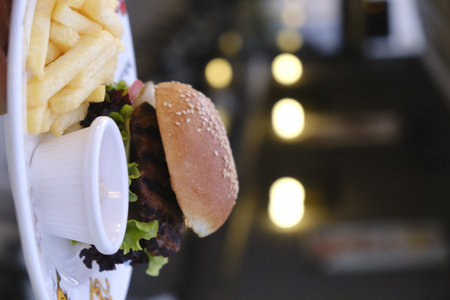 Burger and french fries on the table in the restaurant, fast foodの写真素材