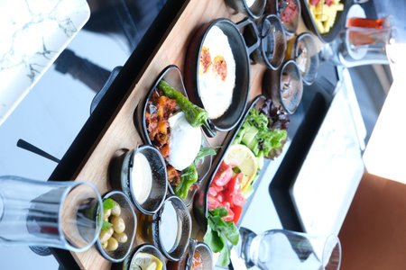 Tray with different appetizers on table in restaurant, closeupの写真素材