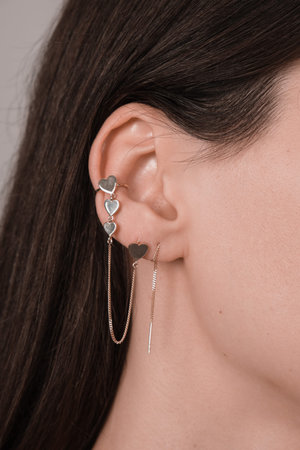 Heart-shaped earring with chain.