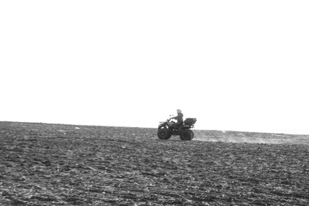 person riding atv quad bike in mountains