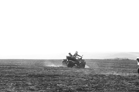 helmet sitting on atv quad bike in mountainsの写真素材