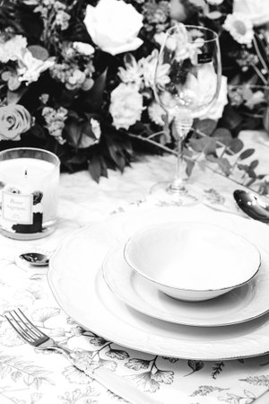 beautiful plate and fresh perfect colorful flowers standing on luxury tableの写真素材