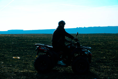 man riding atv quad bike in mountains