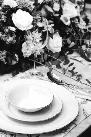 beautiful plate and fresh perfect colorful flowers standing on luxury table