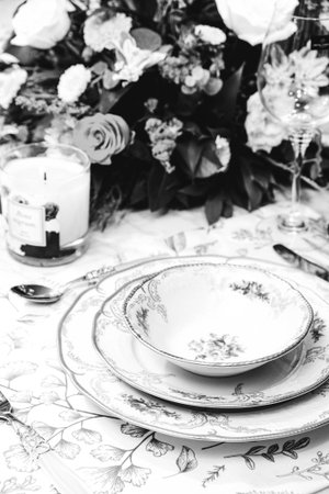 beautiful plate and fresh perfect colorful flowers standing on luxury tableの写真素材
