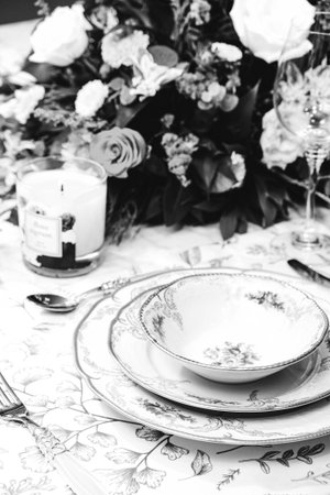 beautiful plate and fresh perfect colorful flowers standing on luxury tableの写真素材