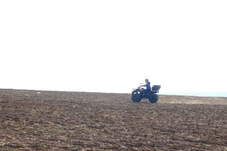 person riding atv quad bike on plainの写真素材