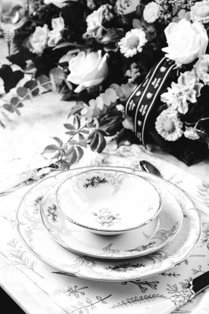 beautiful plate and fresh perfect colorful flowers standing on luxury tableの写真素材