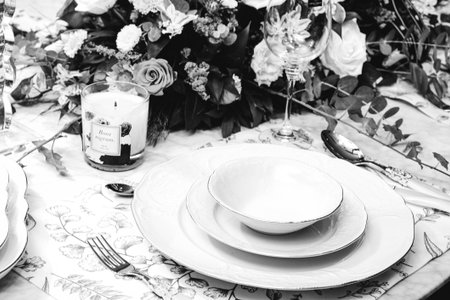 beautiful plate and fresh perfect colorful flowers standing on luxury tableの写真素材