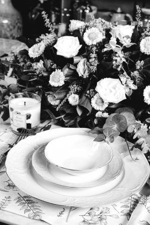 beautiful plate and fresh perfect colorful flowers standing on luxury table
