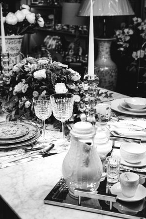 beautiful plate and fresh perfect colorful flowers standing on luxury tableの写真素材