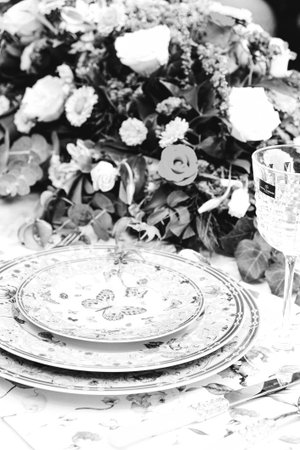 beautiful plate and fresh perfect colorful flowers standing on luxury table