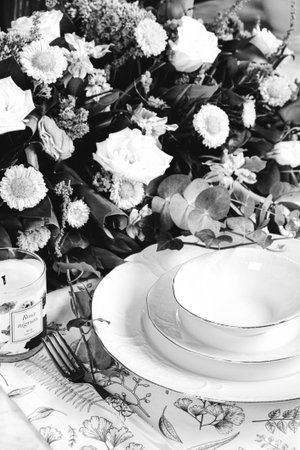 beautiful plate and fresh perfect colorful flowers standing on luxury tableの写真素材