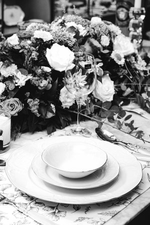 beautiful plate and fresh perfect colorful flowers standing on luxury tableの写真素材