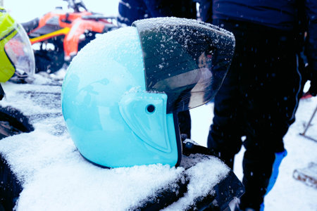 helmet sitting on atv quad bike in mountainsの写真素材