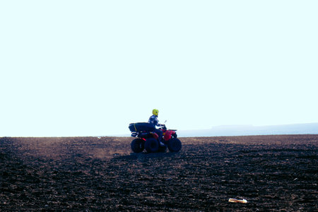helmet sitting on atv quad bike in mountainsの写真素材