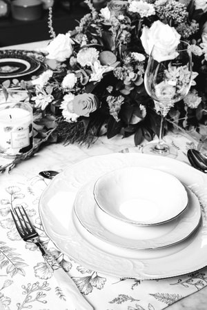 beautiful plate and fresh perfect colorful flowers standing on luxury tableの写真素材