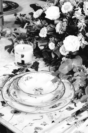 beautiful plate and fresh perfect colorful flowers standing on luxury tableの写真素材