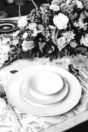 beautiful plate and fresh perfect colorful flowers standing on luxury tableの写真素材