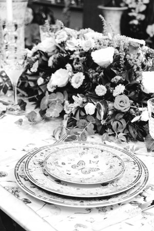 beautiful plate and fresh perfect colorful flowers standing on luxury table