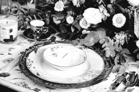 beautiful plate and fresh perfect colorful flowers standing on luxury tableの写真素材