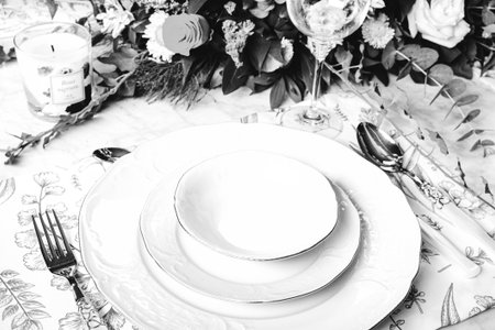 beautiful plate and fresh perfect colorful flowers standing on luxury tableの写真素材