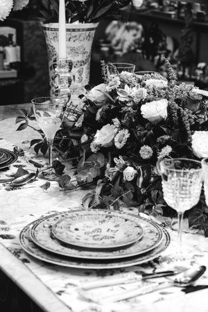 beautiful plate and fresh perfect colorful flowers standing on luxury table