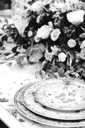 beautiful plate and fresh perfect colorful flowers standing on luxury tableの写真素材