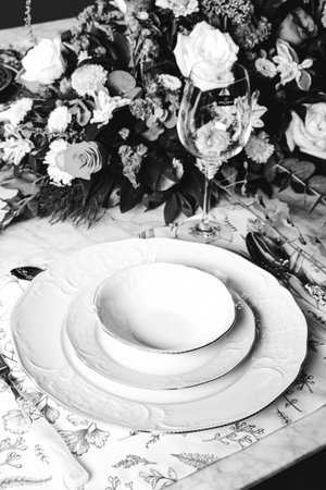 beautiful plate and fresh perfect colorful flowers standing on luxury tableの写真素材