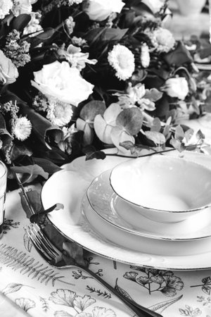 beautiful plate and fresh perfect colorful flowers standing on luxury tableの写真素材