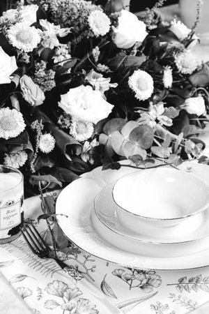 beautiful plate and fresh perfect colorful flowers standing on luxury table