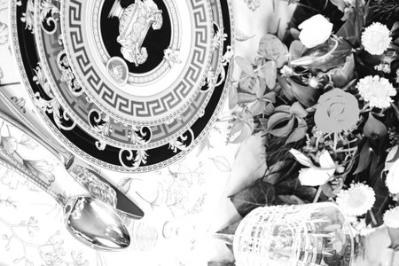 beautiful plate and fresh perfect colorful flowers standing on luxury tableの写真素材