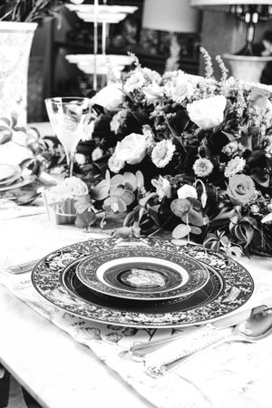 beautiful plate and fresh perfect colorful flowers standing on luxury tableの写真素材
