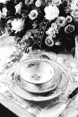 beautiful plate and fresh perfect colorful flowers standing on luxury tableの写真素材
