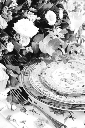beautiful plate and fresh perfect colorful flowers standing on luxury table