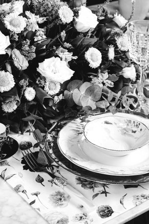 beautiful plate and fresh perfect colorful flowers standing on luxury tableの写真素材