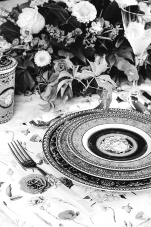 beautiful plate and fresh perfect colorful flowers standing on luxury tableの写真素材